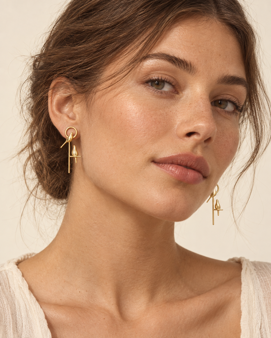 Model wearing the Perch Earrings in 18K gold vermeil, hair pinned back
