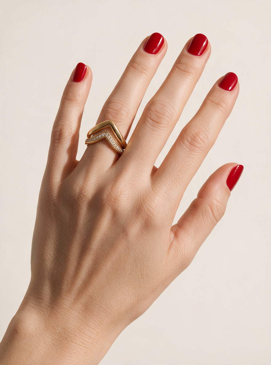 Peak Ring in 18K gold vermeil with white stones on a hand with red nails