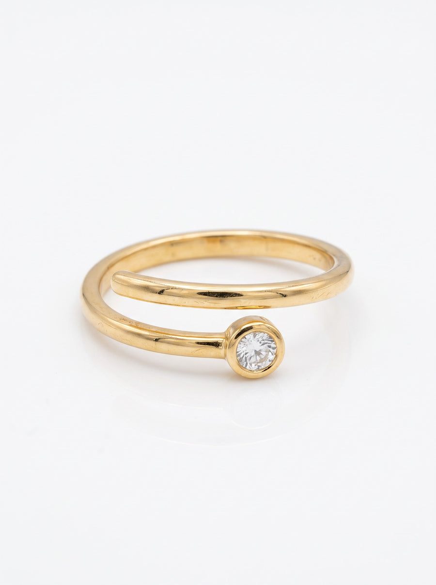 Coil Ring in 18K gold vermeil with a white stone where two thin coiled bands meet