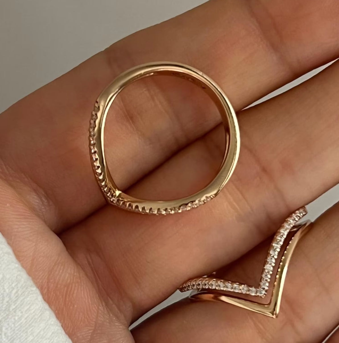 Peak Ring in 18K gold vermeil with white pavé, held in the palm of a hand