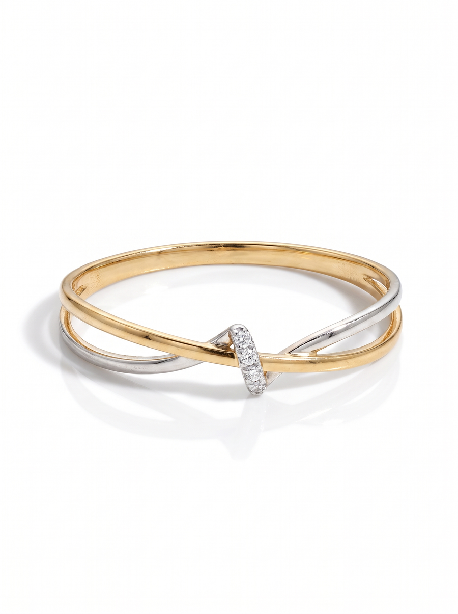 Cinch Ring in two-tone gold and silver: a twisted band pulled in at one point, traced with pavé