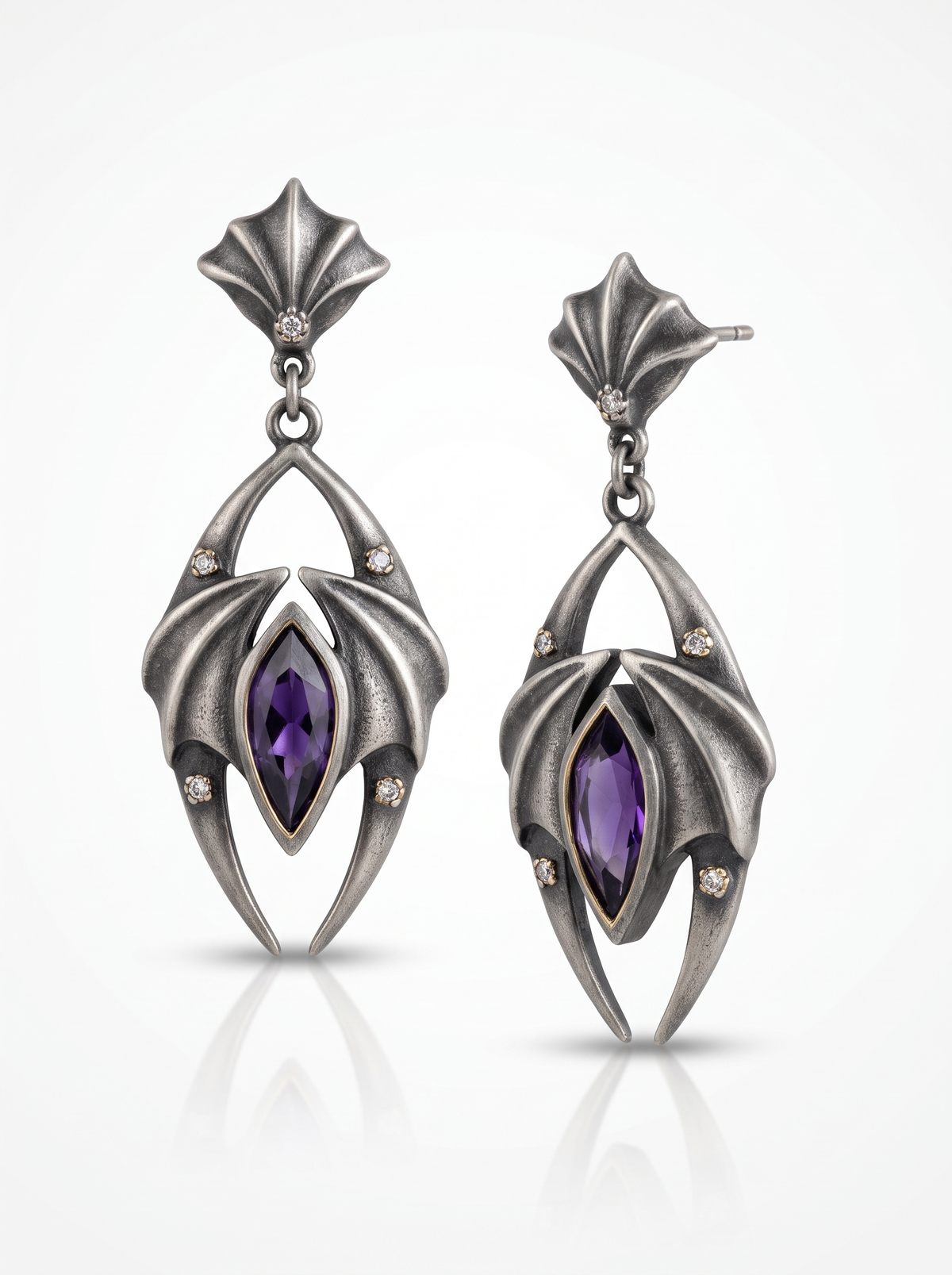 Nocturne Earrings in oxidised silver: bat-wing panels folded around a purple stone