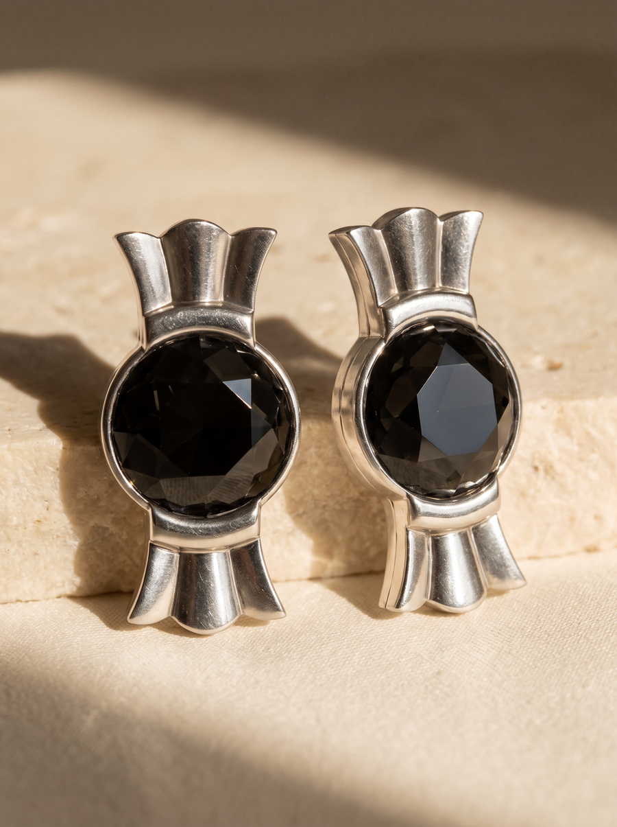 Crown Studs in sterling silver with black faceted stones on sunlit travertine