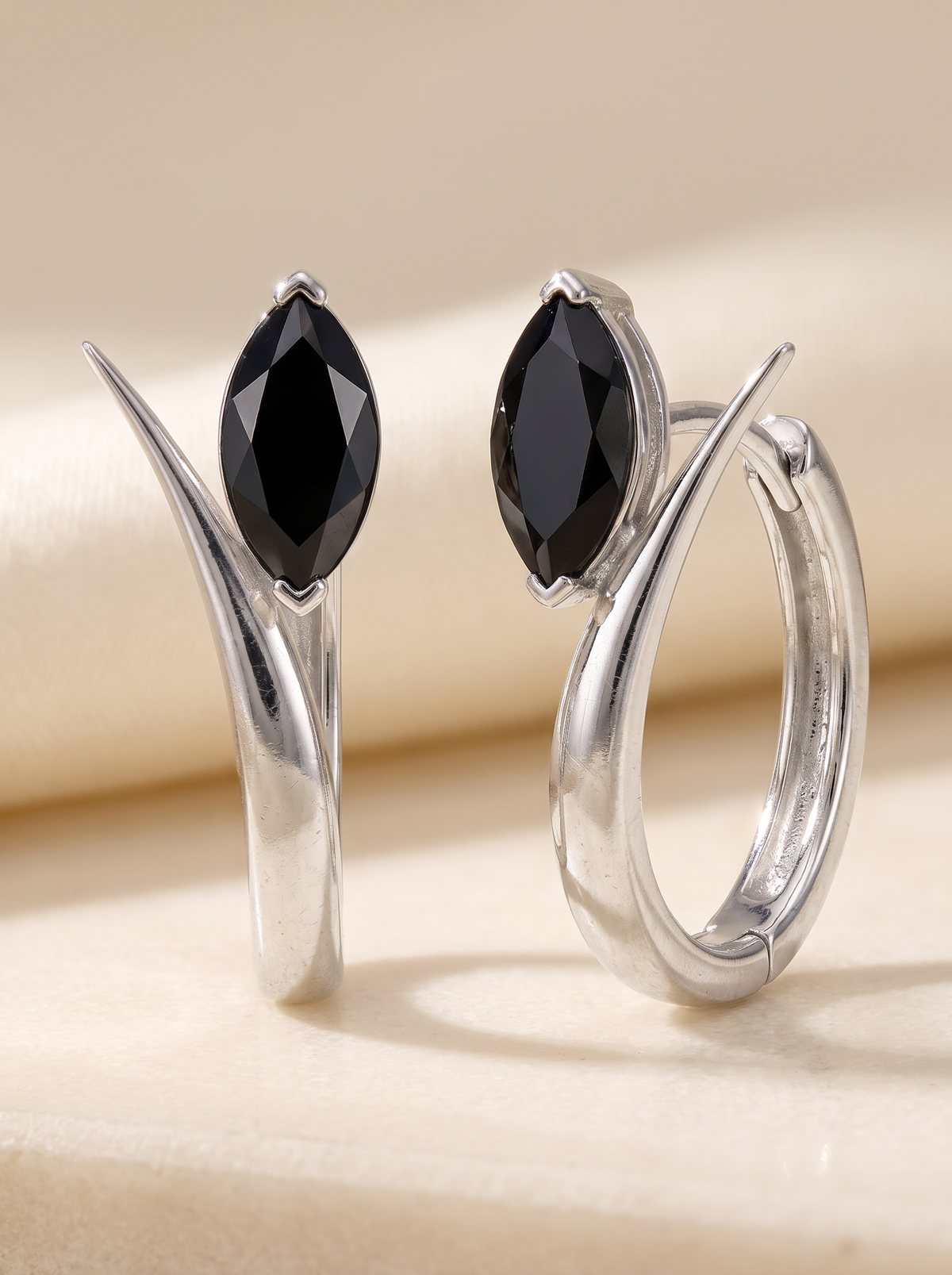 Leaf Hoops in sterling silver with black marquise stones on cream