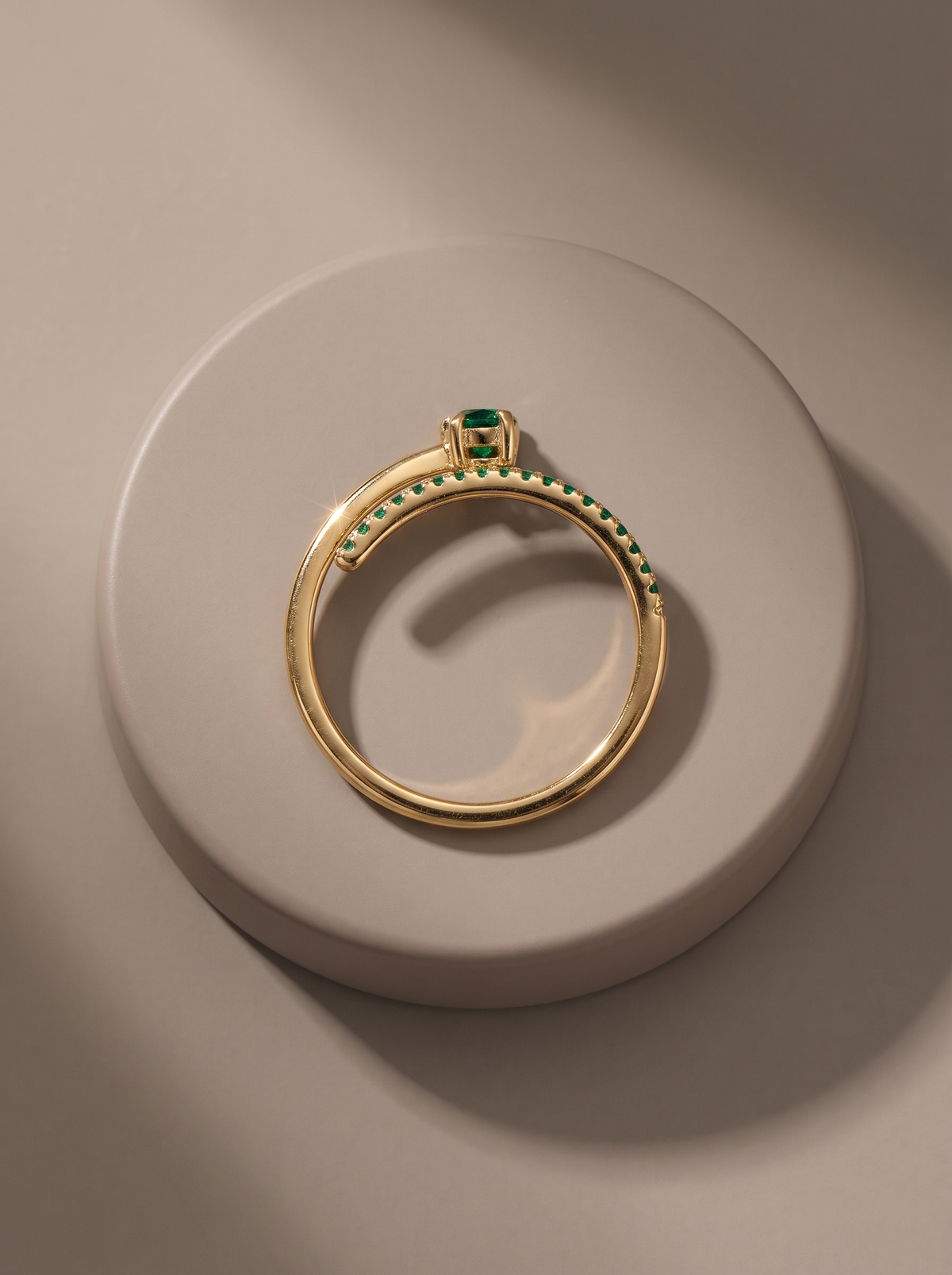 Comet Ring in 18K gold vermeil with a green stone and green pavé trail on a round stone plinth