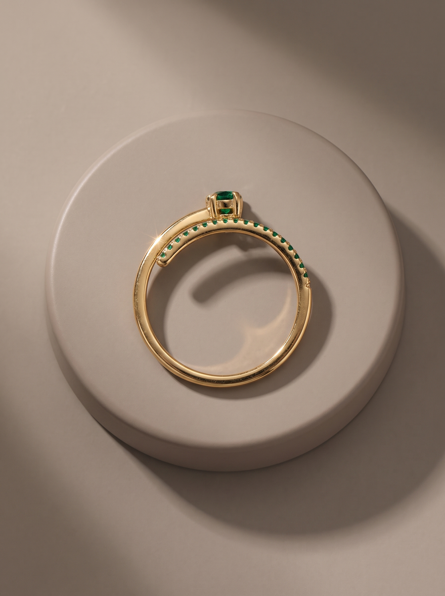 Comet Ring in 18K gold vermeil with a green stone and green pavé trail on a round stone plinth