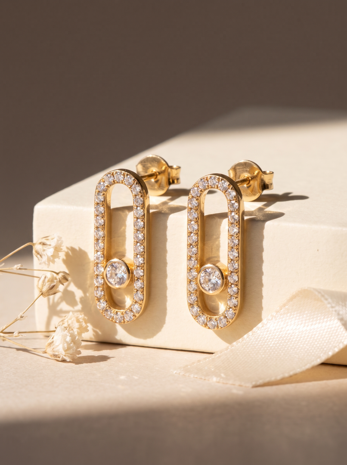 Pavé Link Earrings in 18K gold vermeil on a cream block with dried flowers