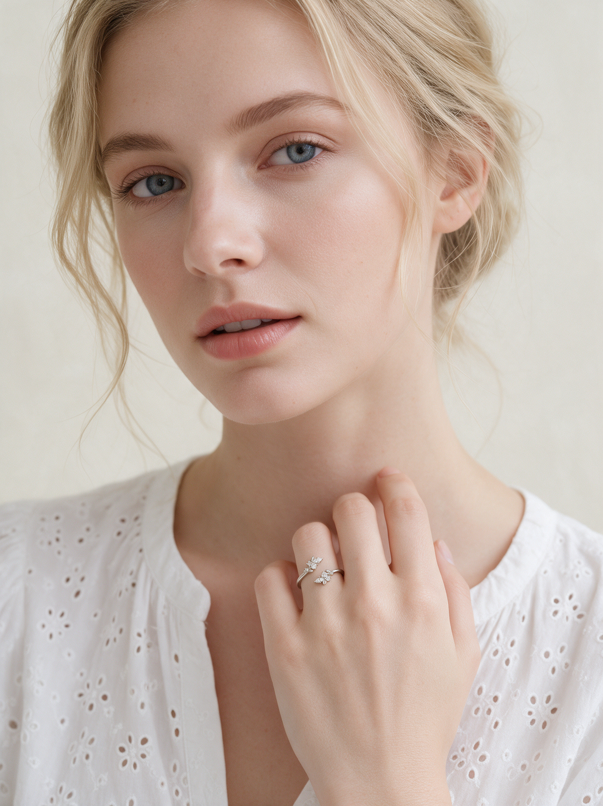 Model in a white eyelet blouse wearing the Bloom Ring in sterling silver with white stones