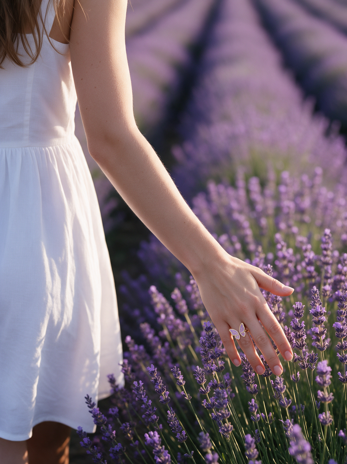 Lavender Butterfly Ring in 18K gold vermeil on a hand trailing through a lavender field