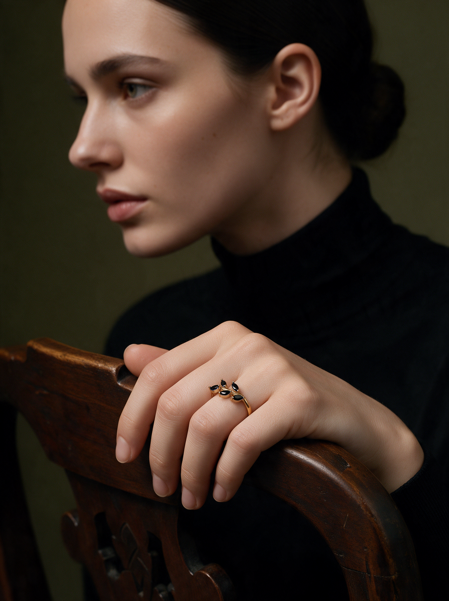Model in a black turtleneck wearing the Laurel Ring in 18K gold vermeil with black stones