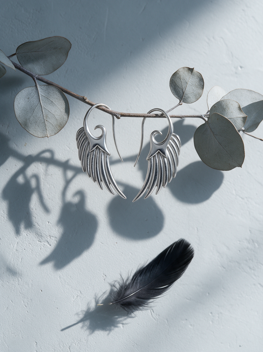 Wing Hook Earrings in Sterling Silver hanging from eucalyptus