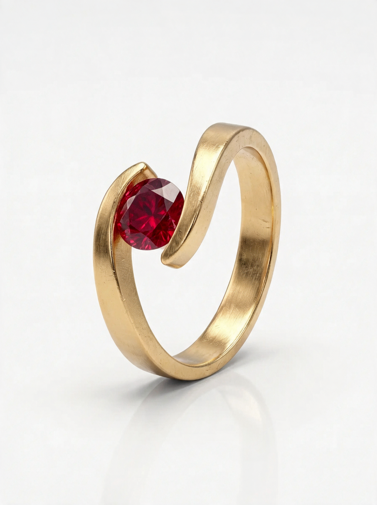 Embrace Ring in 18K gold vermeil with a red stone cradled where the band wraps around itself