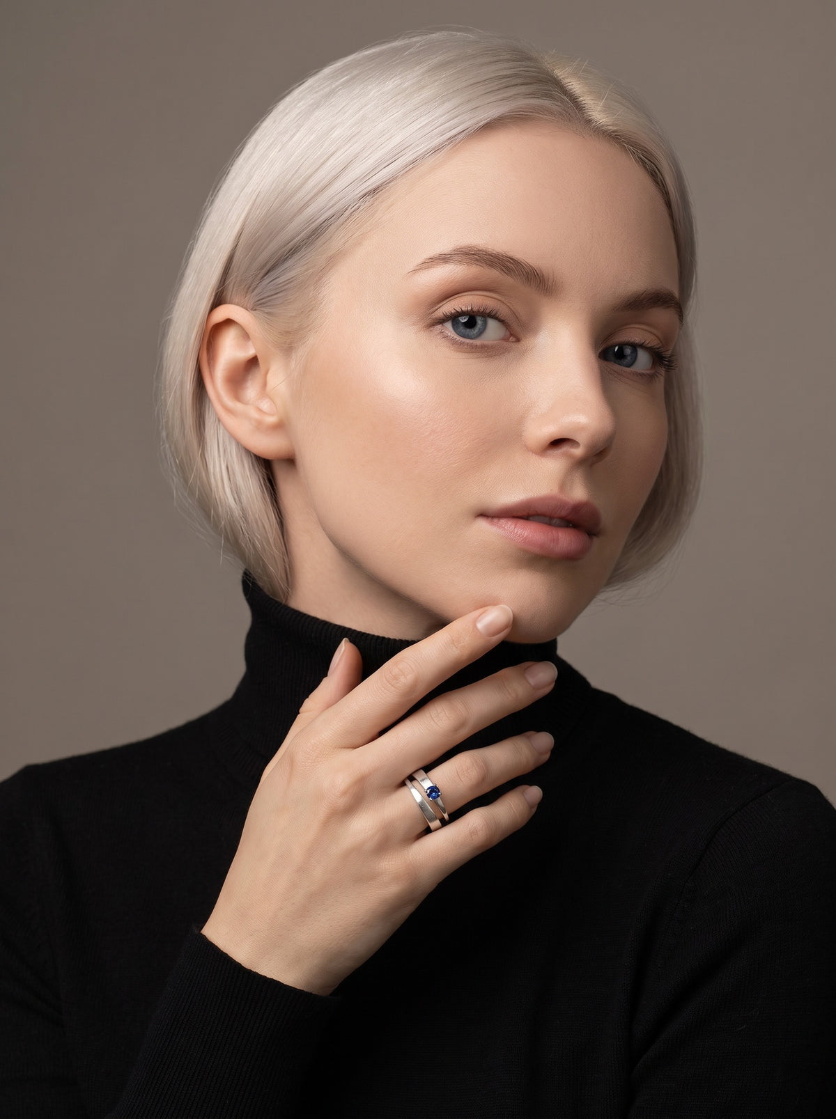 Model wearing the Tier Ring in Sterling Silver with a blue stone